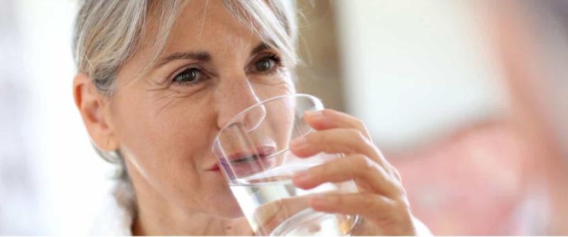 Femme buvant un verre d’eau 